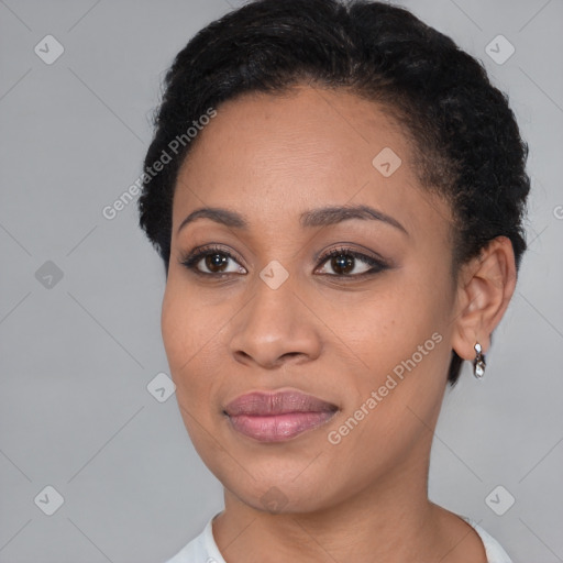 Joyful black young-adult female with short  black hair and brown eyes