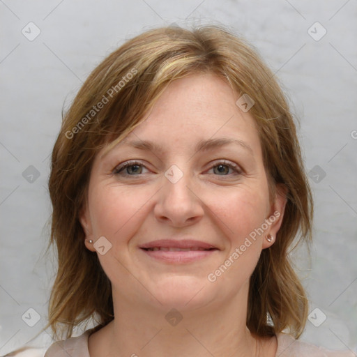 Joyful white young-adult female with medium  brown hair and blue eyes