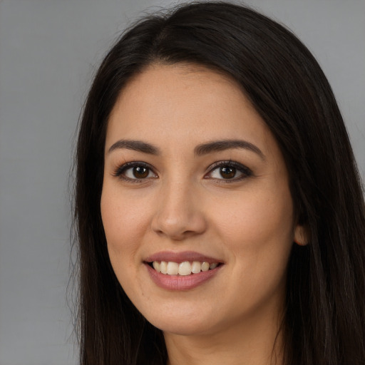 Joyful white young-adult female with long  brown hair and brown eyes