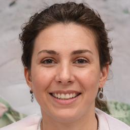 Joyful white young-adult female with medium  brown hair and brown eyes