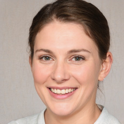 Joyful white young-adult female with medium  brown hair and blue eyes