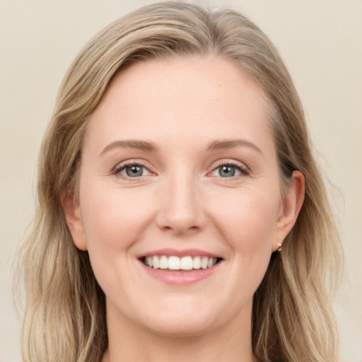 Joyful white young-adult female with long  brown hair and blue eyes