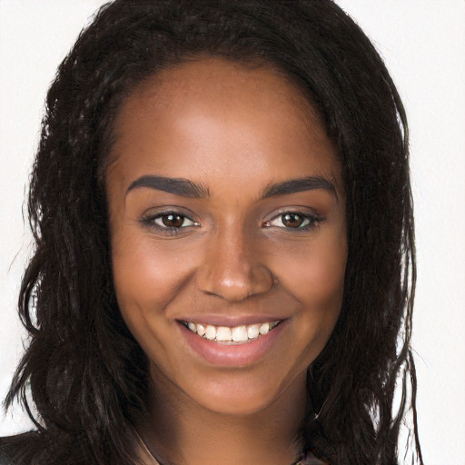 Joyful black young-adult female with long  brown hair and brown eyes