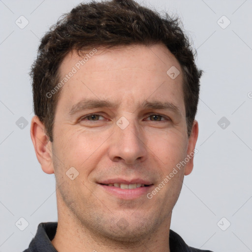 Joyful white adult male with short  brown hair and grey eyes