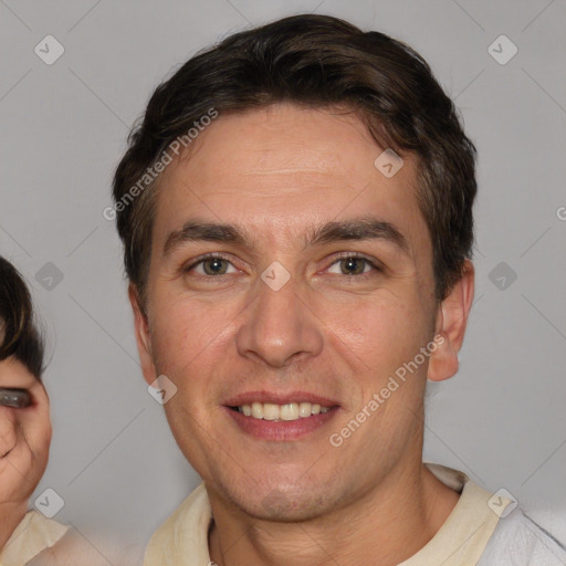 Joyful white adult male with short  brown hair and brown eyes