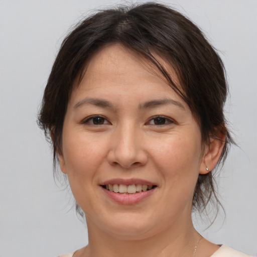 Joyful white adult female with medium  brown hair and brown eyes