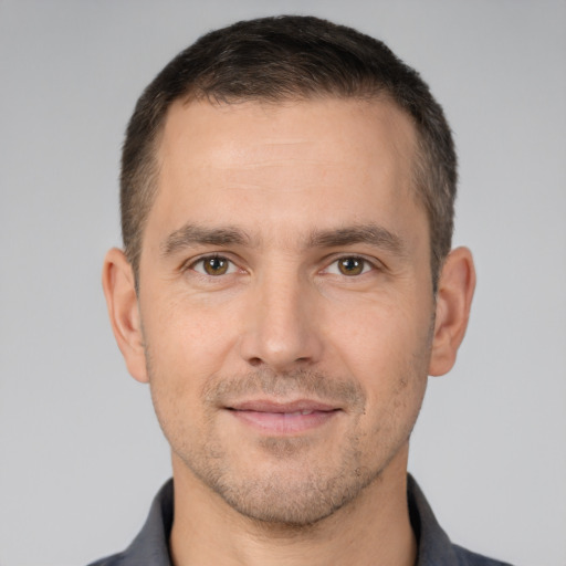 Joyful white young-adult male with short  brown hair and brown eyes