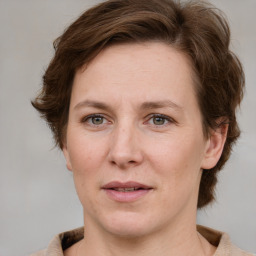 Joyful white adult female with medium  brown hair and grey eyes