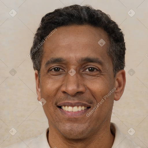 Joyful latino adult male with short  black hair and brown eyes