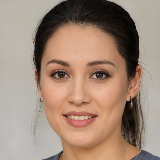 Joyful white young-adult female with medium  brown hair and brown eyes