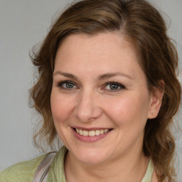 Joyful white adult female with medium  brown hair and brown eyes