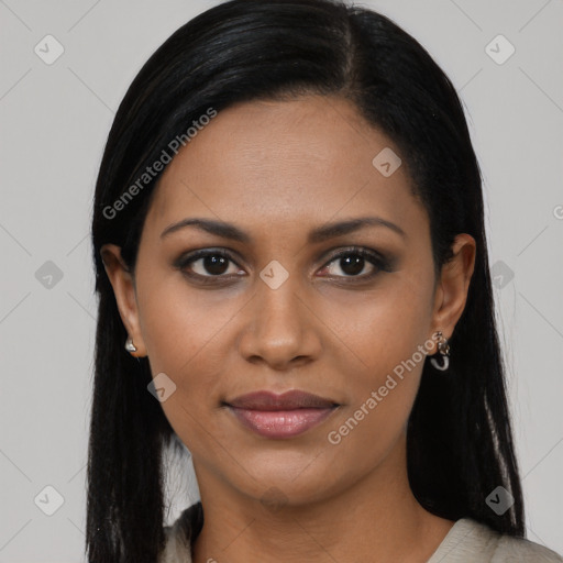 Joyful black young-adult female with long  black hair and brown eyes