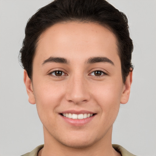 Joyful white young-adult male with short  brown hair and brown eyes