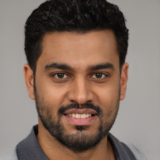 Joyful latino young-adult male with short  black hair and brown eyes