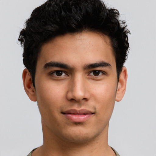 Joyful latino young-adult male with short  brown hair and brown eyes