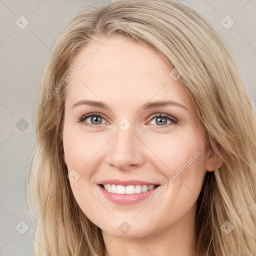 Joyful white young-adult female with long  brown hair and blue eyes