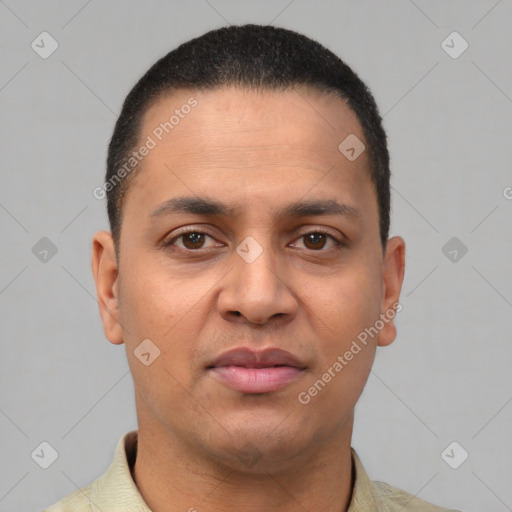 Joyful latino young-adult male with short  brown hair and brown eyes