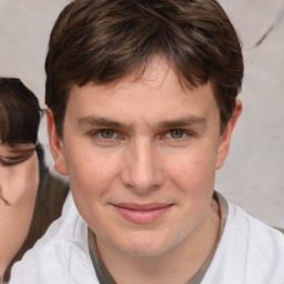 Joyful white young-adult male with medium  brown hair and brown eyes