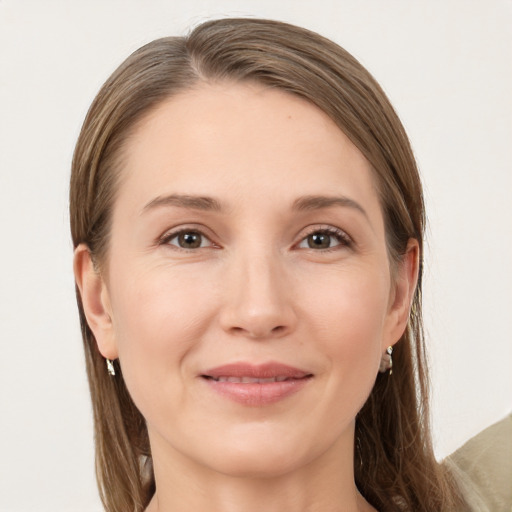 Joyful white young-adult female with long  brown hair and grey eyes