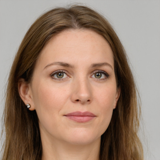 Joyful white young-adult female with long  brown hair and green eyes