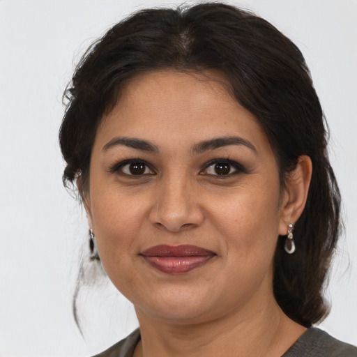 Joyful asian adult female with medium  brown hair and brown eyes