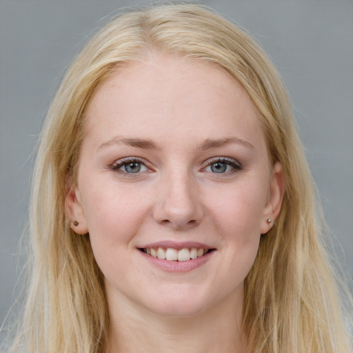 Joyful white young-adult female with long  brown hair and blue eyes