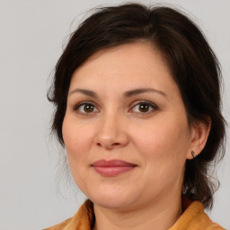 Joyful white adult female with medium  brown hair and brown eyes