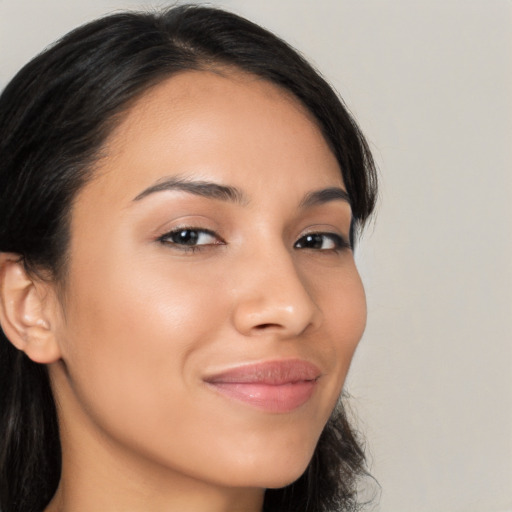 Joyful latino young-adult female with long  brown hair and brown eyes