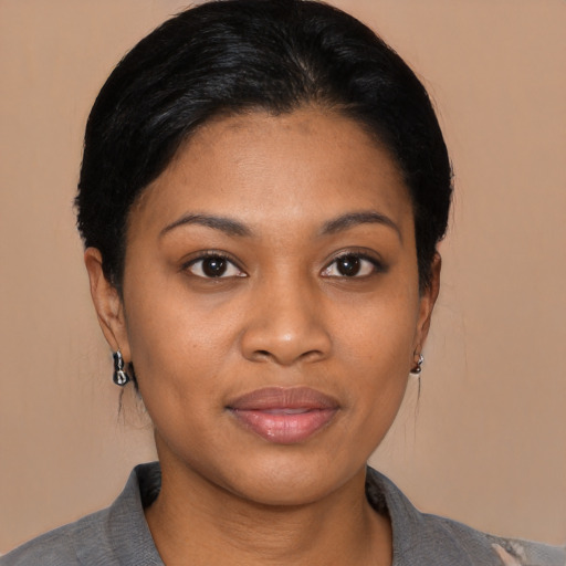 Joyful black young-adult female with medium  black hair and brown eyes