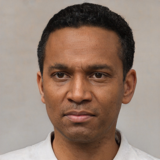 Neutral latino adult male with short  black hair and brown eyes