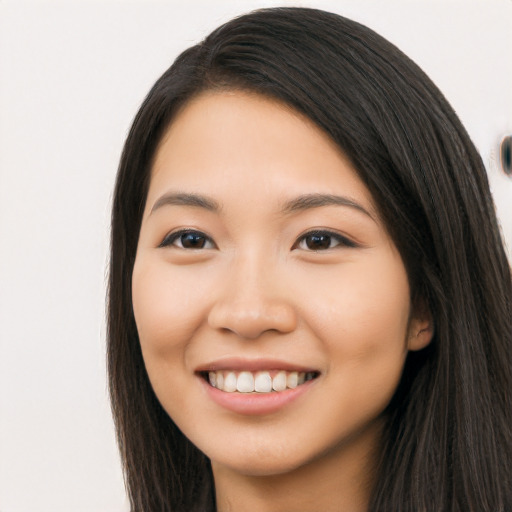 Joyful latino young-adult female with long  black hair and brown eyes