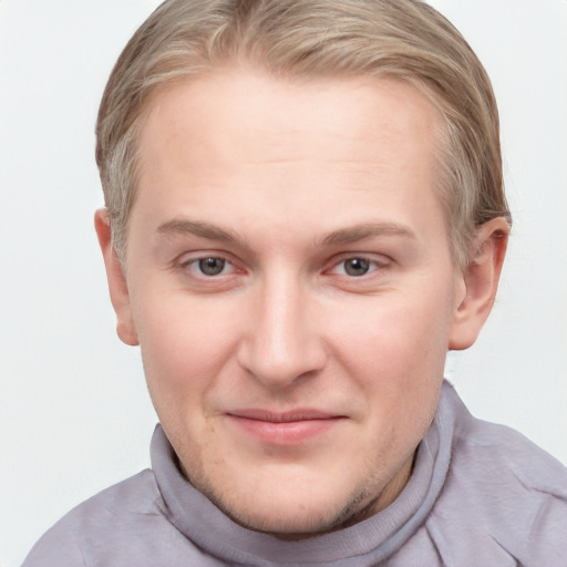 Joyful white young-adult male with short  brown hair and blue eyes