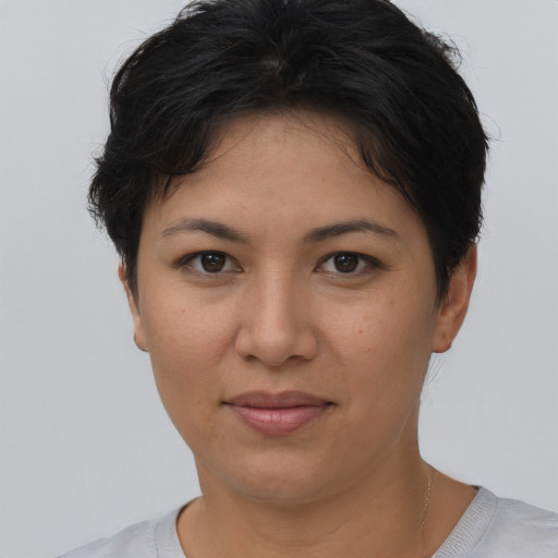 Joyful asian young-adult female with short  brown hair and brown eyes