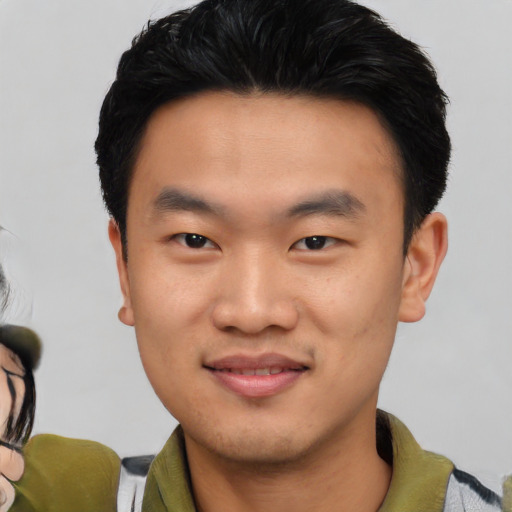 Joyful asian young-adult male with short  black hair and brown eyes