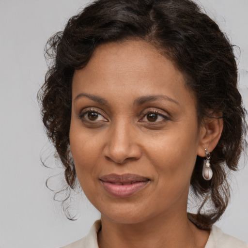 Joyful white adult female with medium  brown hair and brown eyes