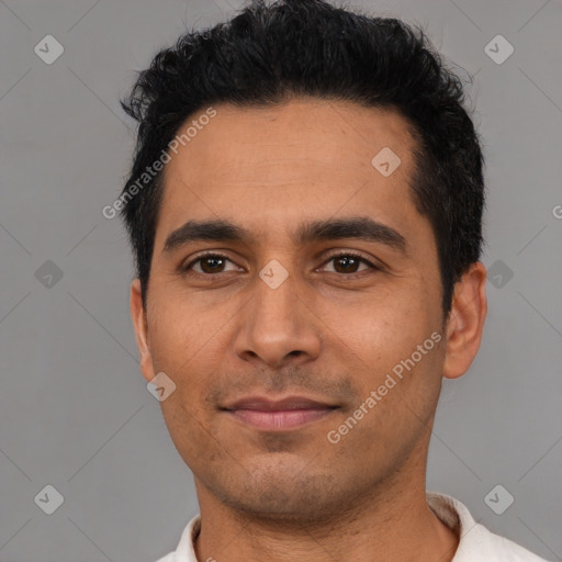 Joyful latino young-adult male with short  black hair and brown eyes