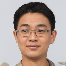 Joyful asian young-adult male with short  brown hair and brown eyes