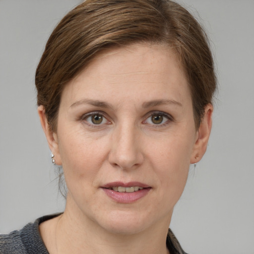 Joyful white adult female with short  brown hair and grey eyes