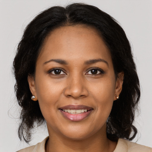 Joyful black adult female with medium  brown hair and brown eyes