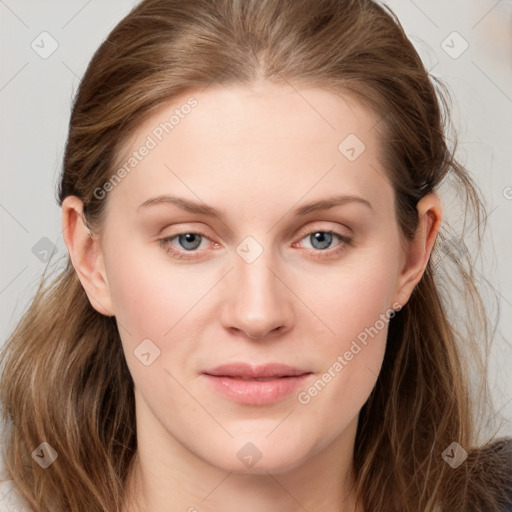 Joyful white young-adult female with long  brown hair and blue eyes