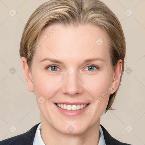 Joyful white adult female with medium  brown hair and blue eyes