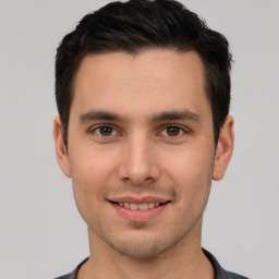 Joyful white young-adult male with short  brown hair and brown eyes