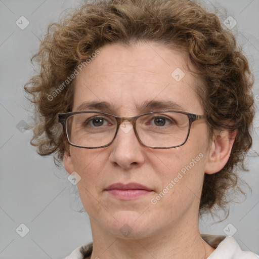 Joyful white adult female with medium  brown hair and blue eyes