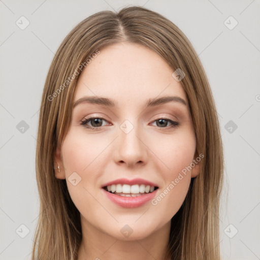 Joyful white young-adult female with long  brown hair and green eyes