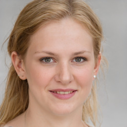 Joyful white young-adult female with medium  brown hair and blue eyes