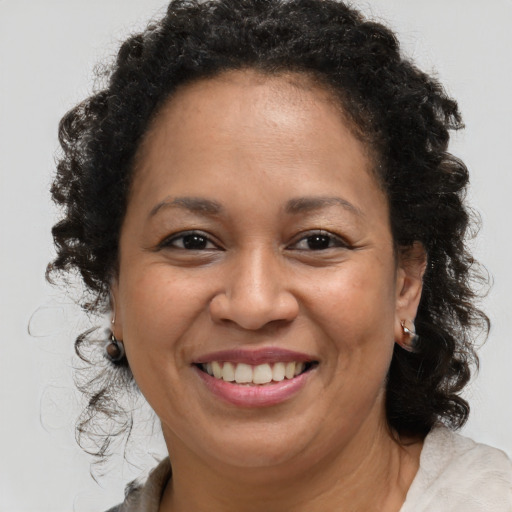 Joyful black young-adult female with medium  brown hair and brown eyes