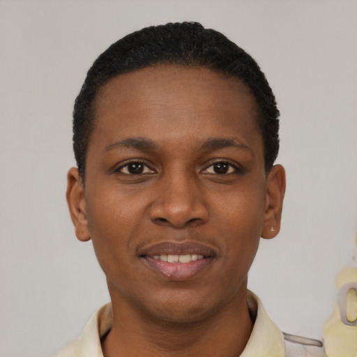 Joyful black young-adult male with short  black hair and brown eyes