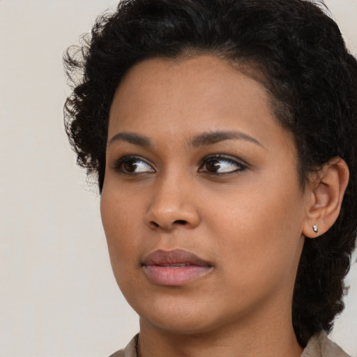 Neutral black young-adult female with medium  brown hair and brown eyes