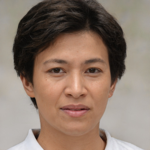 Joyful white adult female with short  brown hair and brown eyes