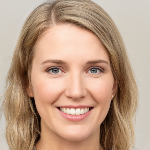 Joyful white young-adult female with long  brown hair and green eyes